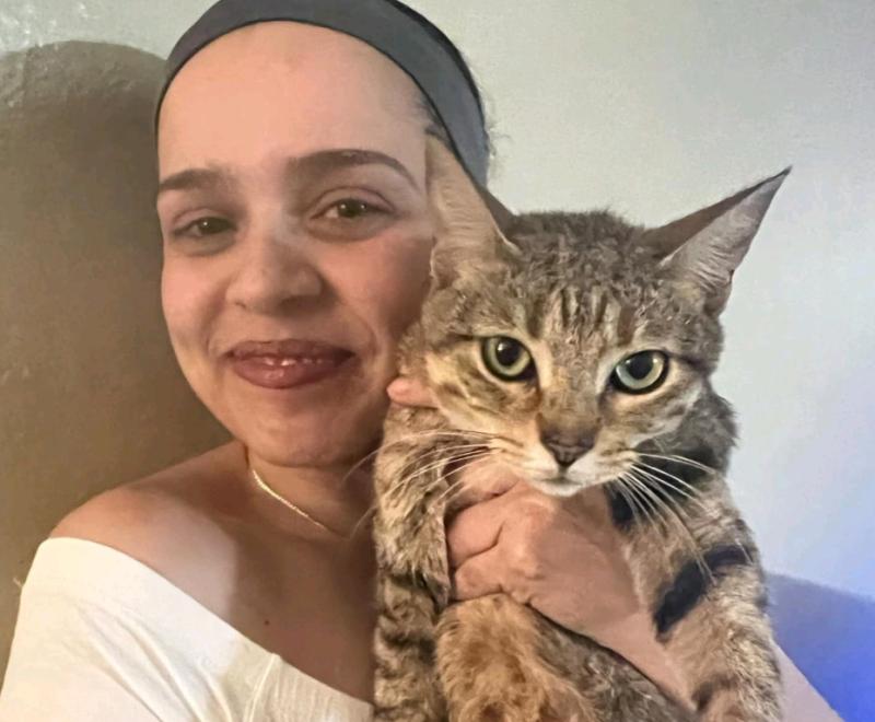 Lourdes Ortiz holding Kiwi the cat